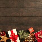 Festive Christmas gifts and decorations on rustic wood background perfect for holiday themes.