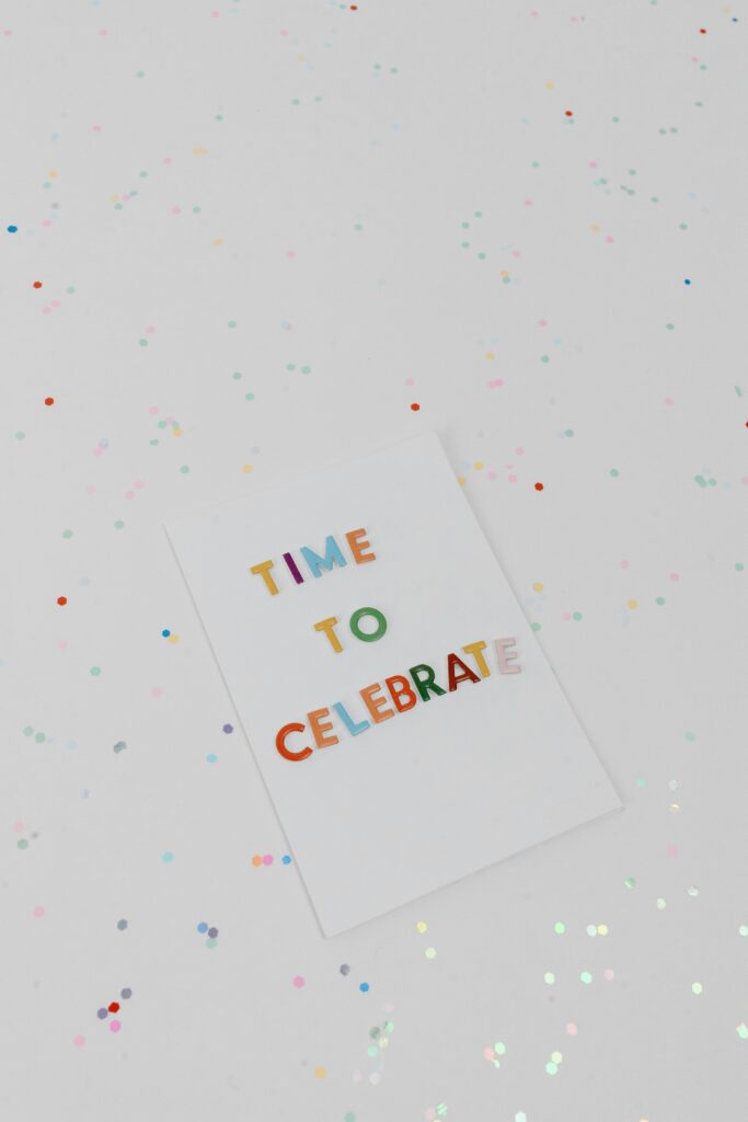 Vibrant 'Time to Celebrate' greeting card surrounded by confetti.